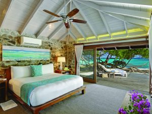 A villa leads directly to the white sand beach at Petit St. Vincent luxury hotel